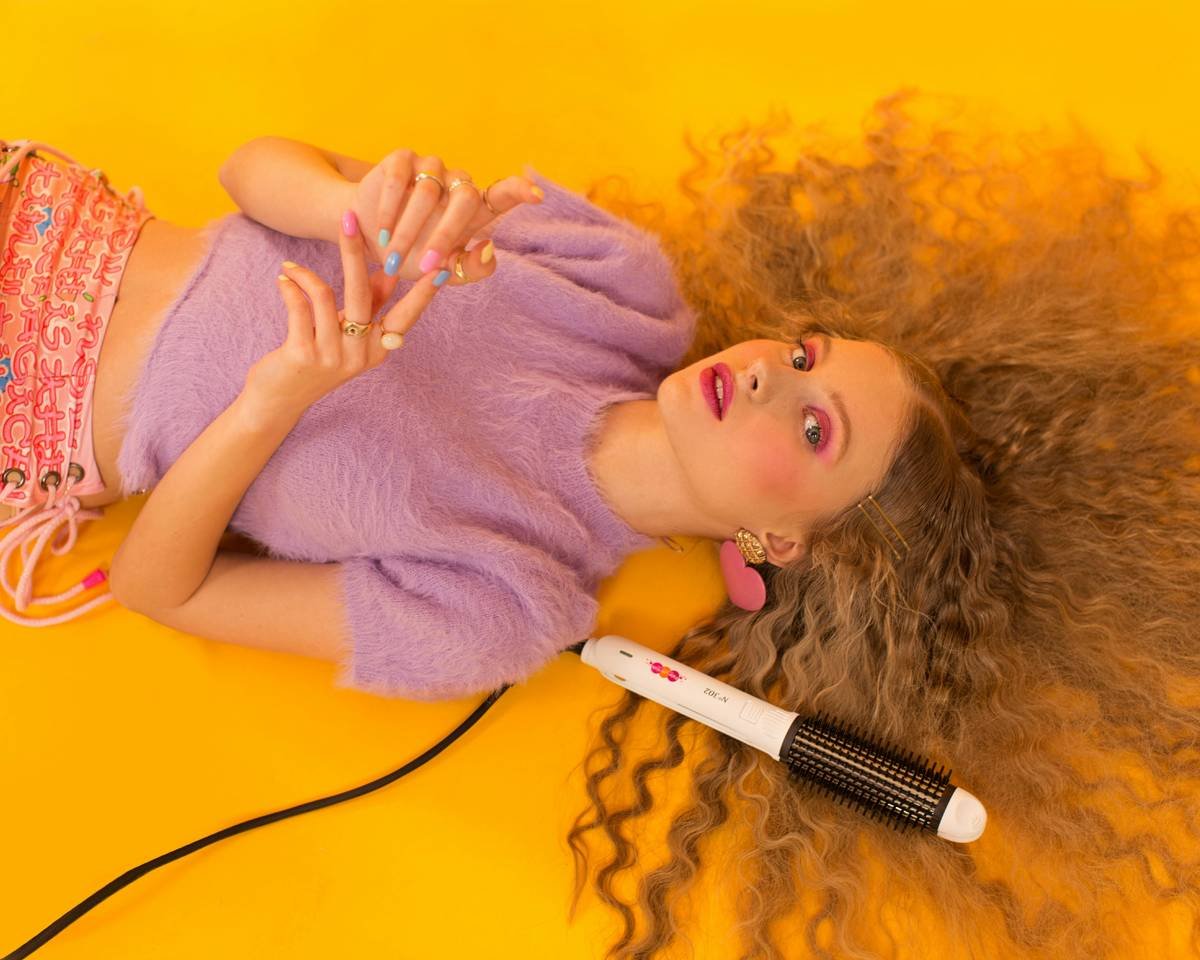 Woman applying bond-building serum for perm hair protection