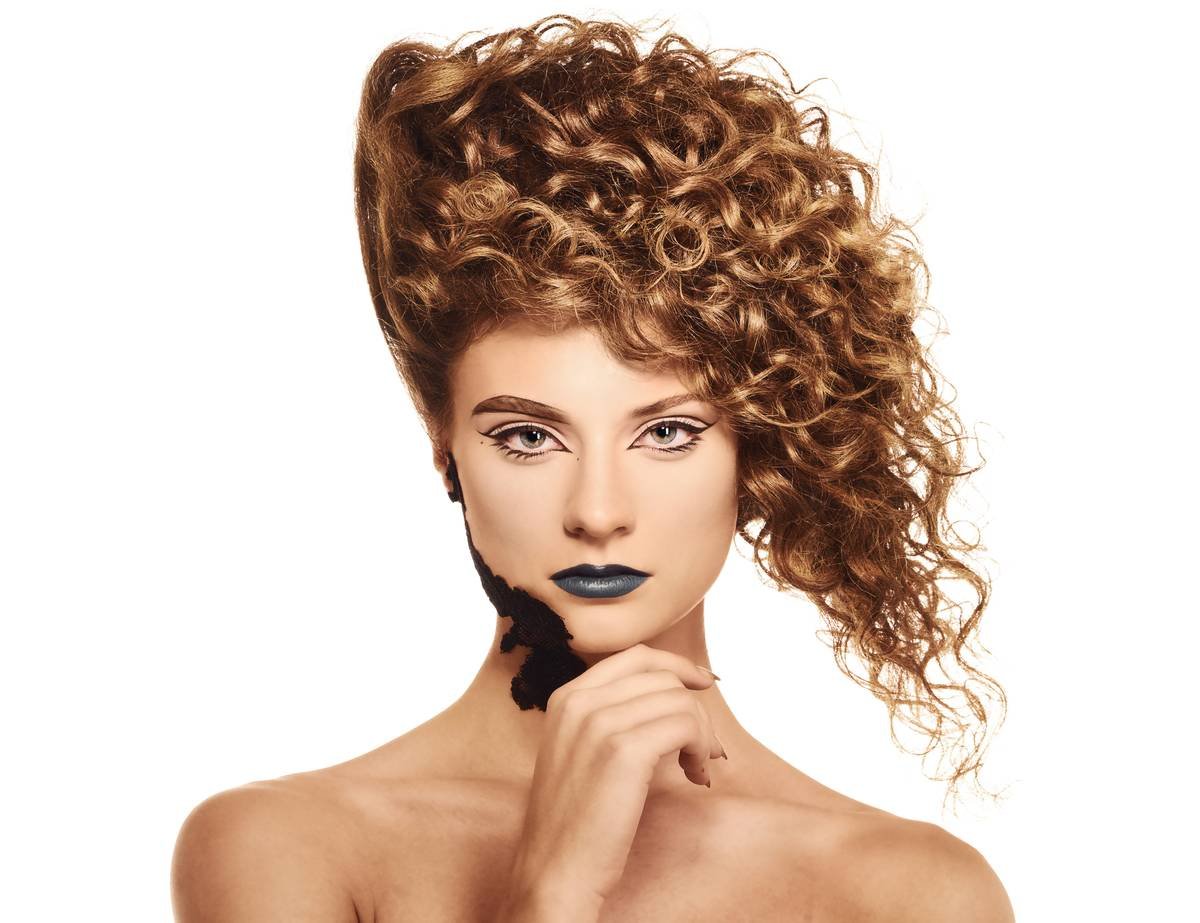 Professional stylist applying modern perm styling methods with precision rod placement