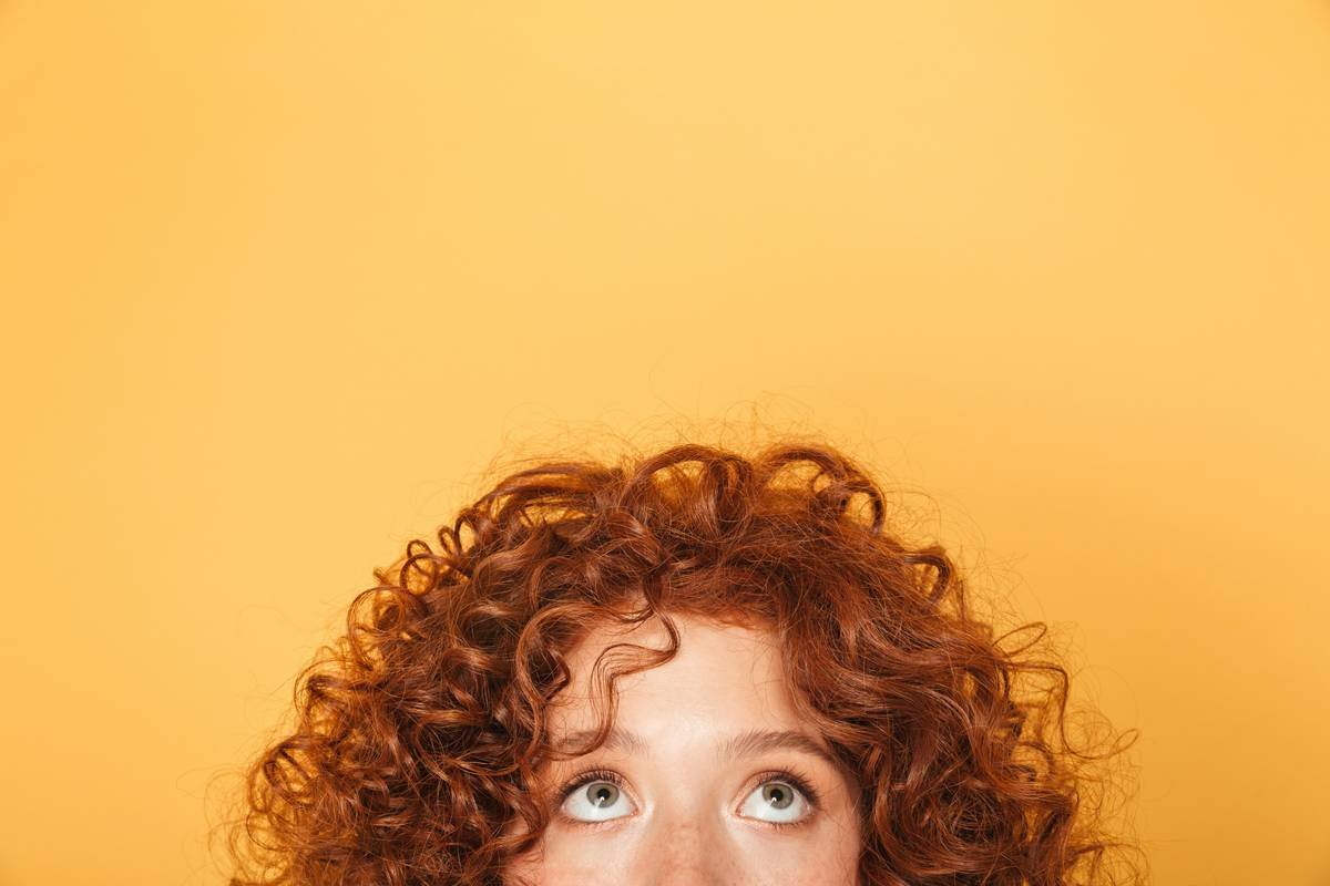 Close-up of hydrated permed curls showing shine and definition from proper perm hair hydration